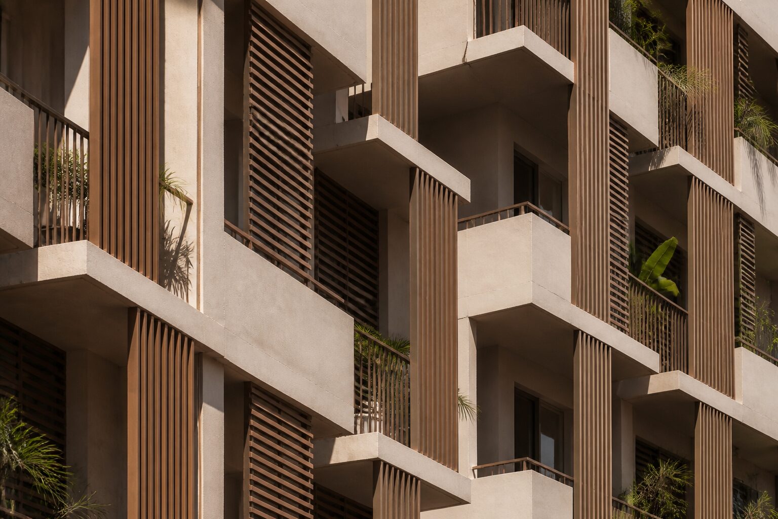 Repeating balconies and sun-shading fins on a tropical residential building